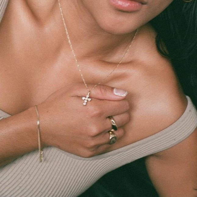 gold cross pendant with CZ stones