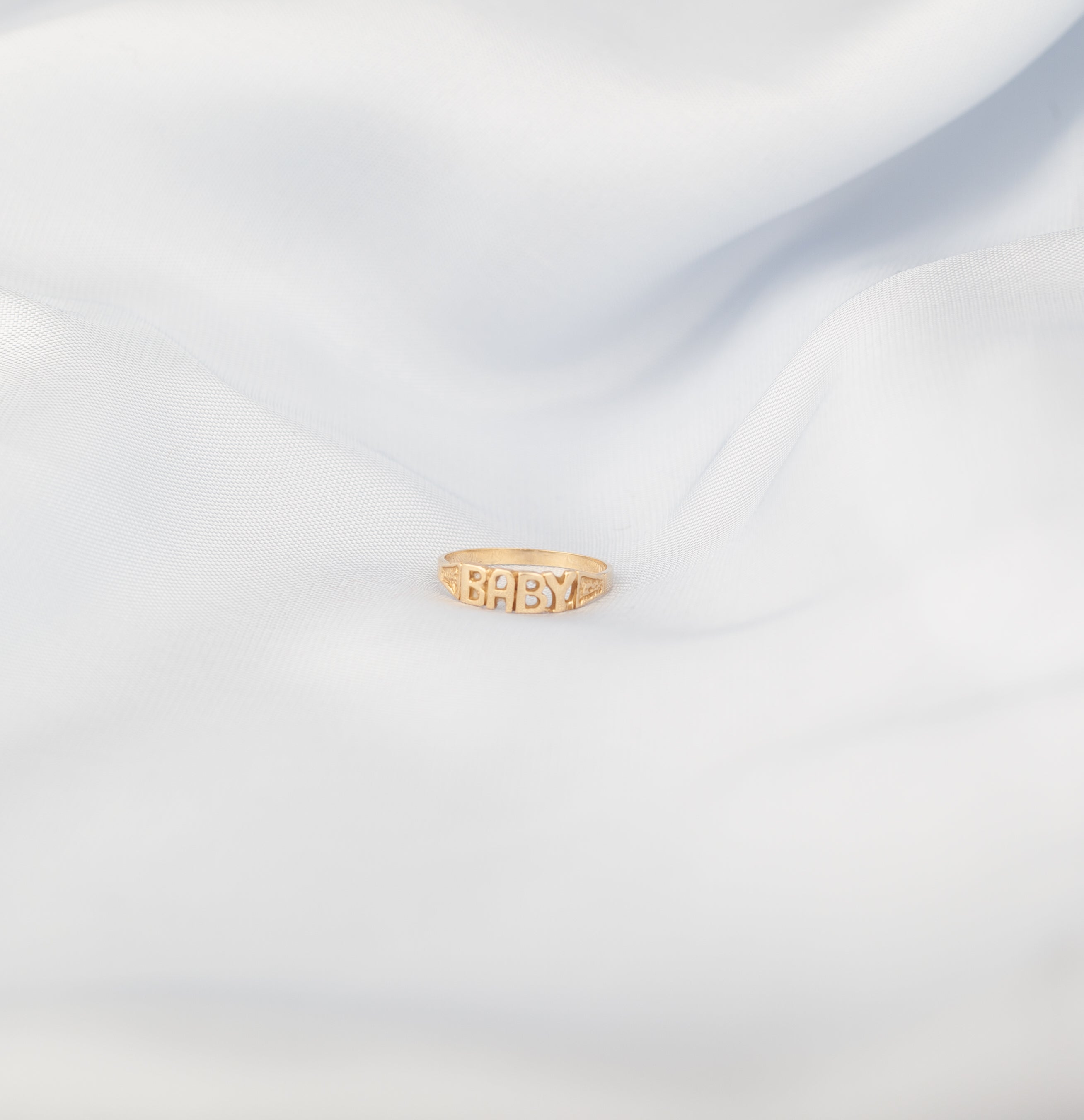 10K yellow gold baby ring with "baby" text