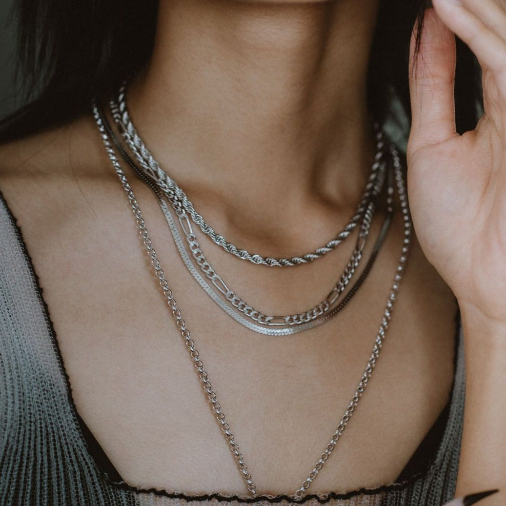 silver Flat Snake Chain on figure layered with other necklaces