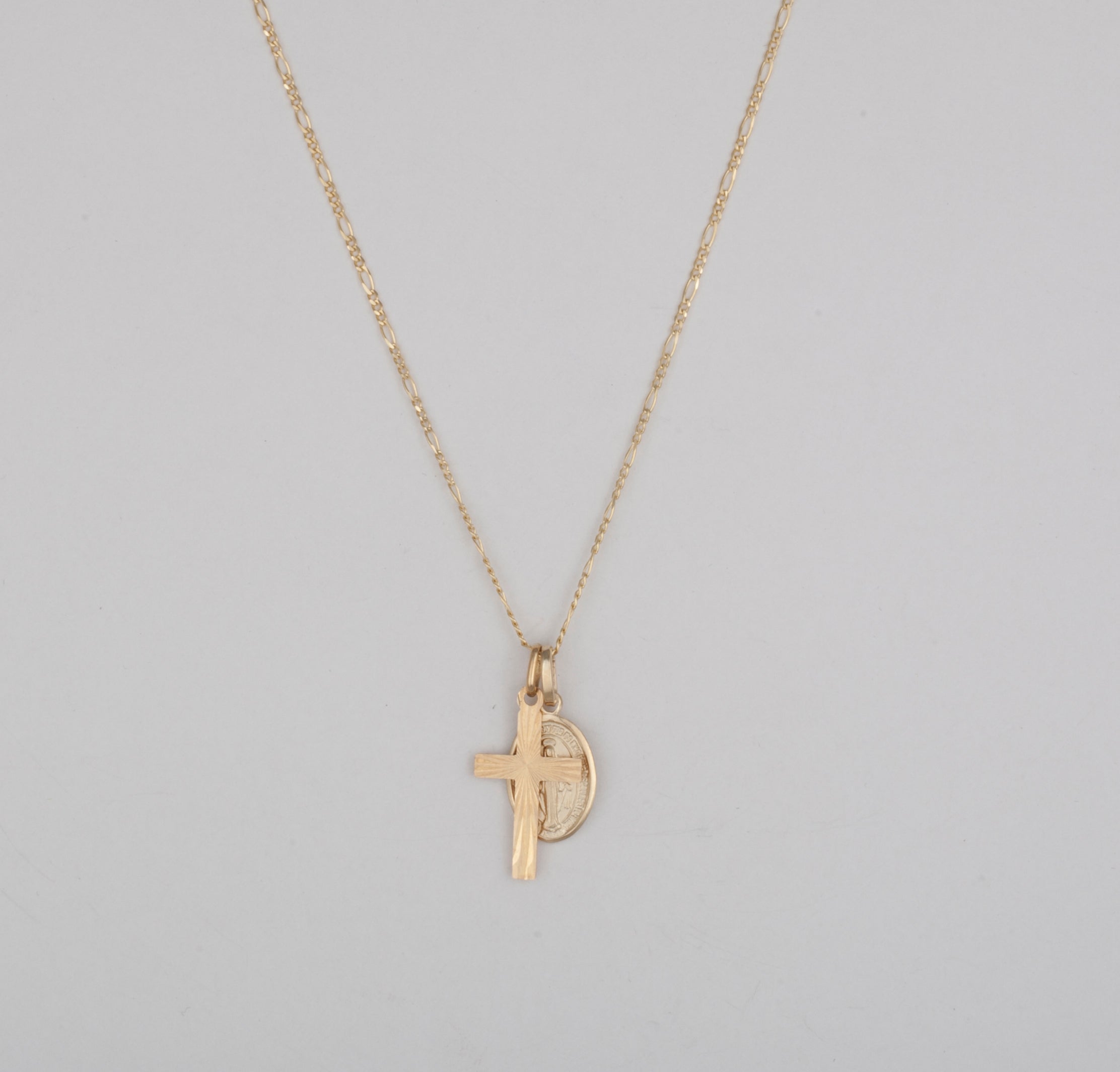10k gold cross and mary pendant on a thin figaro chain
