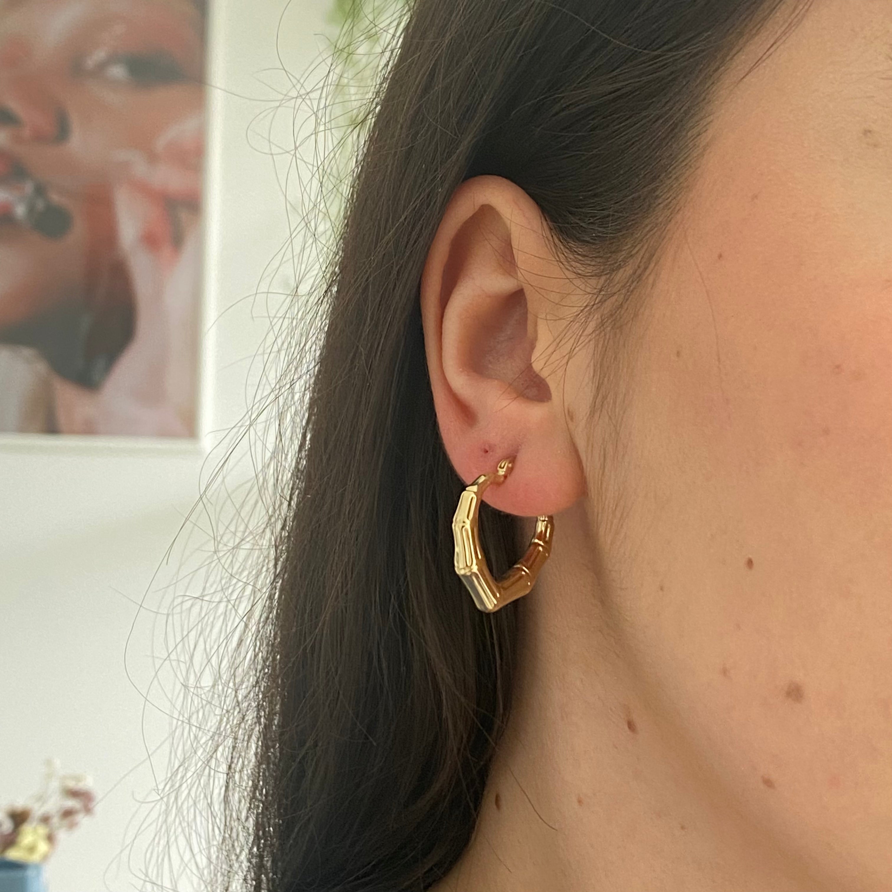 10k Yellow Gold heart bamboo Hollow Hoops on figure