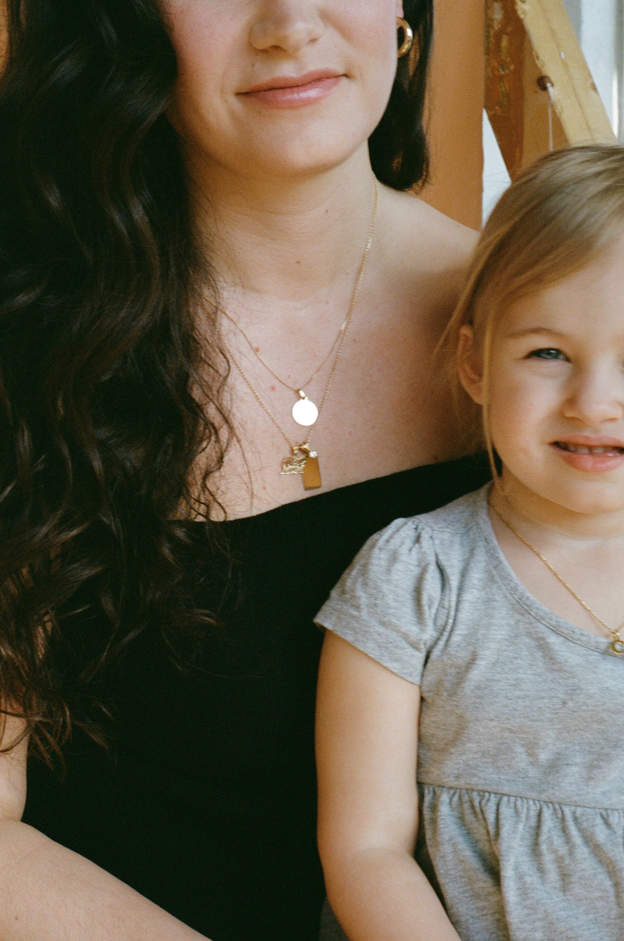 gold circle pendant on a thin curb chain