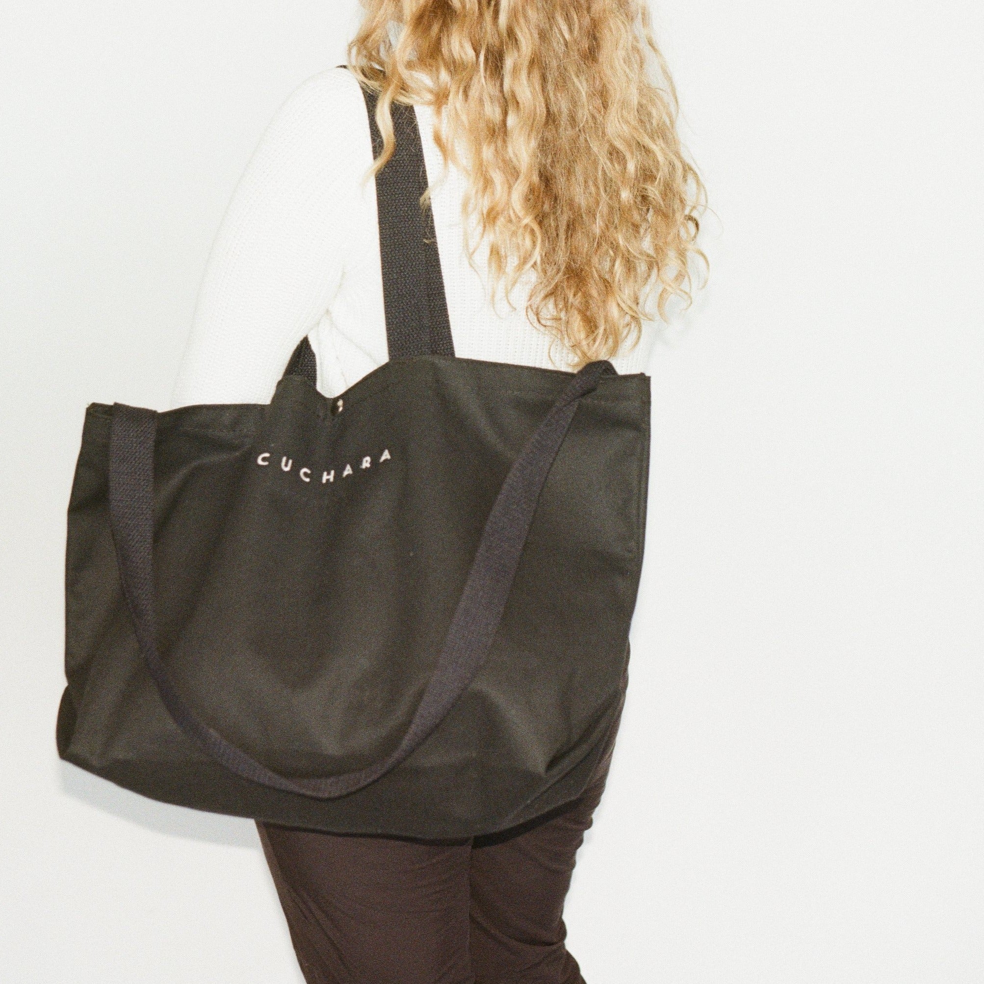 Heavy 15oz Cotton tote bag with Snap Closure in black on model