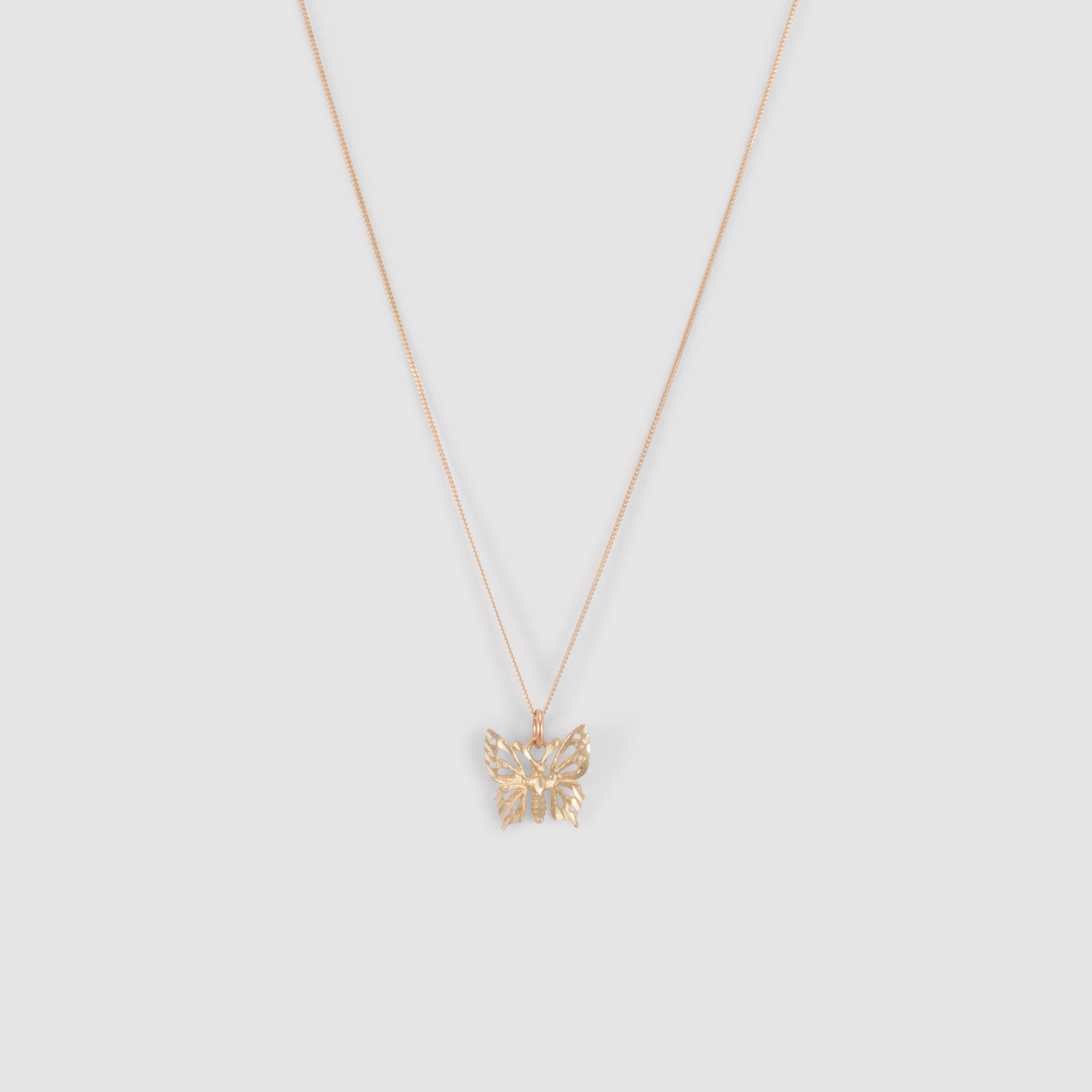 10k yellow gold large butterfly pendant with diamond cut detail. On a thin curb chain