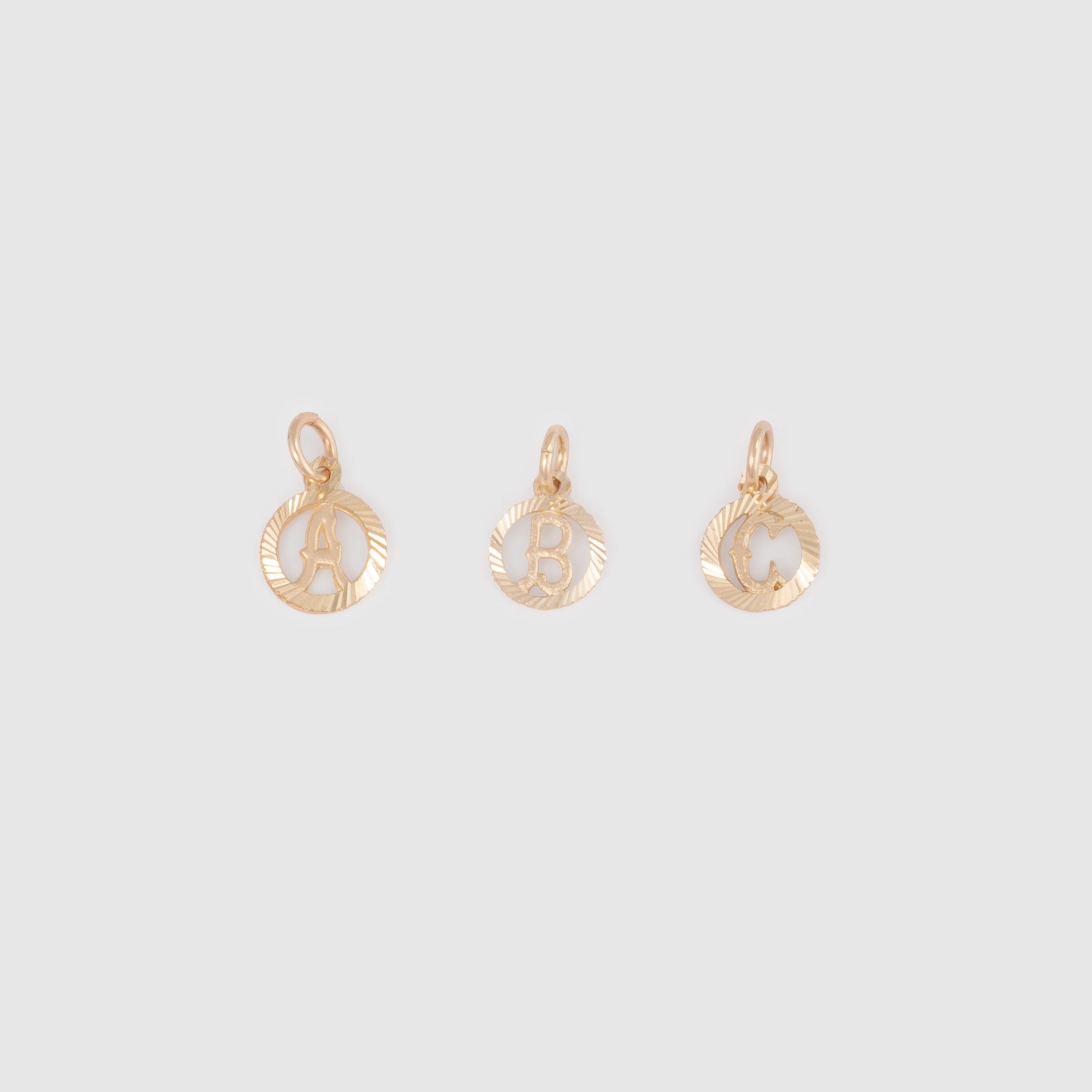 10k solid yellow gold circle initial charms in A, B, and C