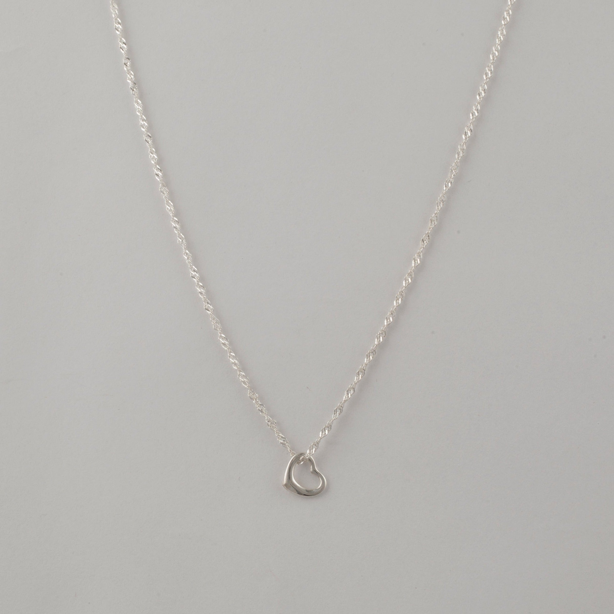 silver Hollow Heart Shaped Necklace on a Singapore Chain