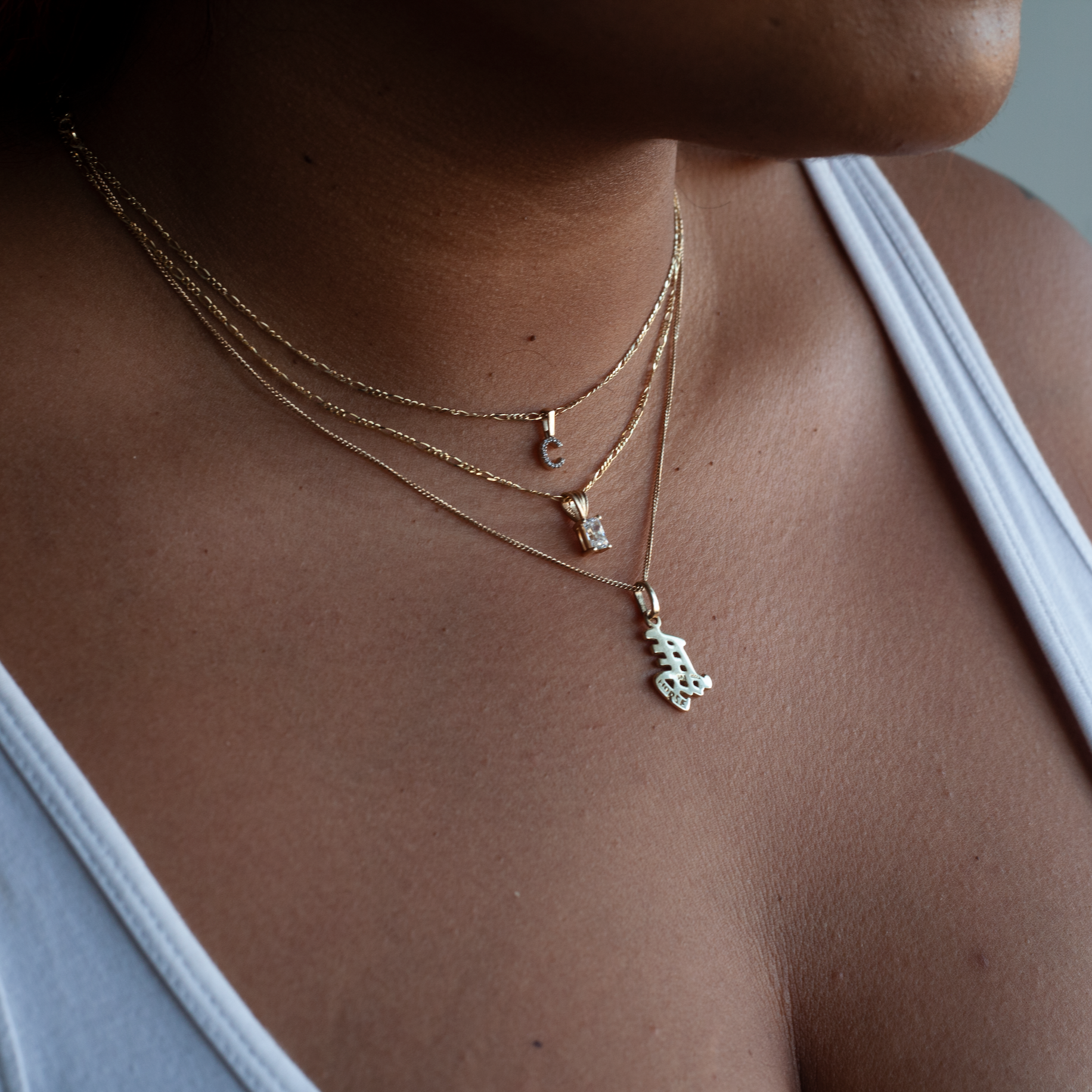 Diamond initial charm on a thin figaro chain