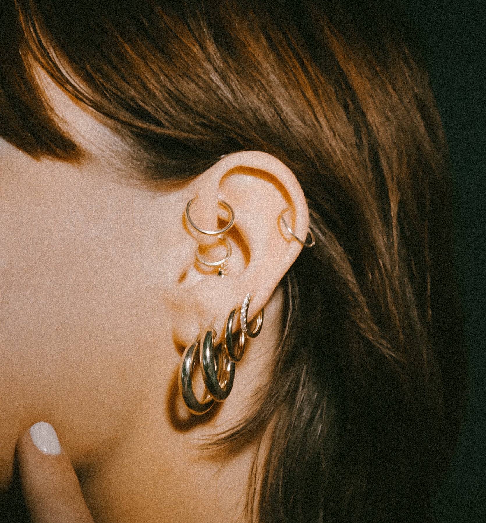 Huggie with cz stone in an earring stack on model