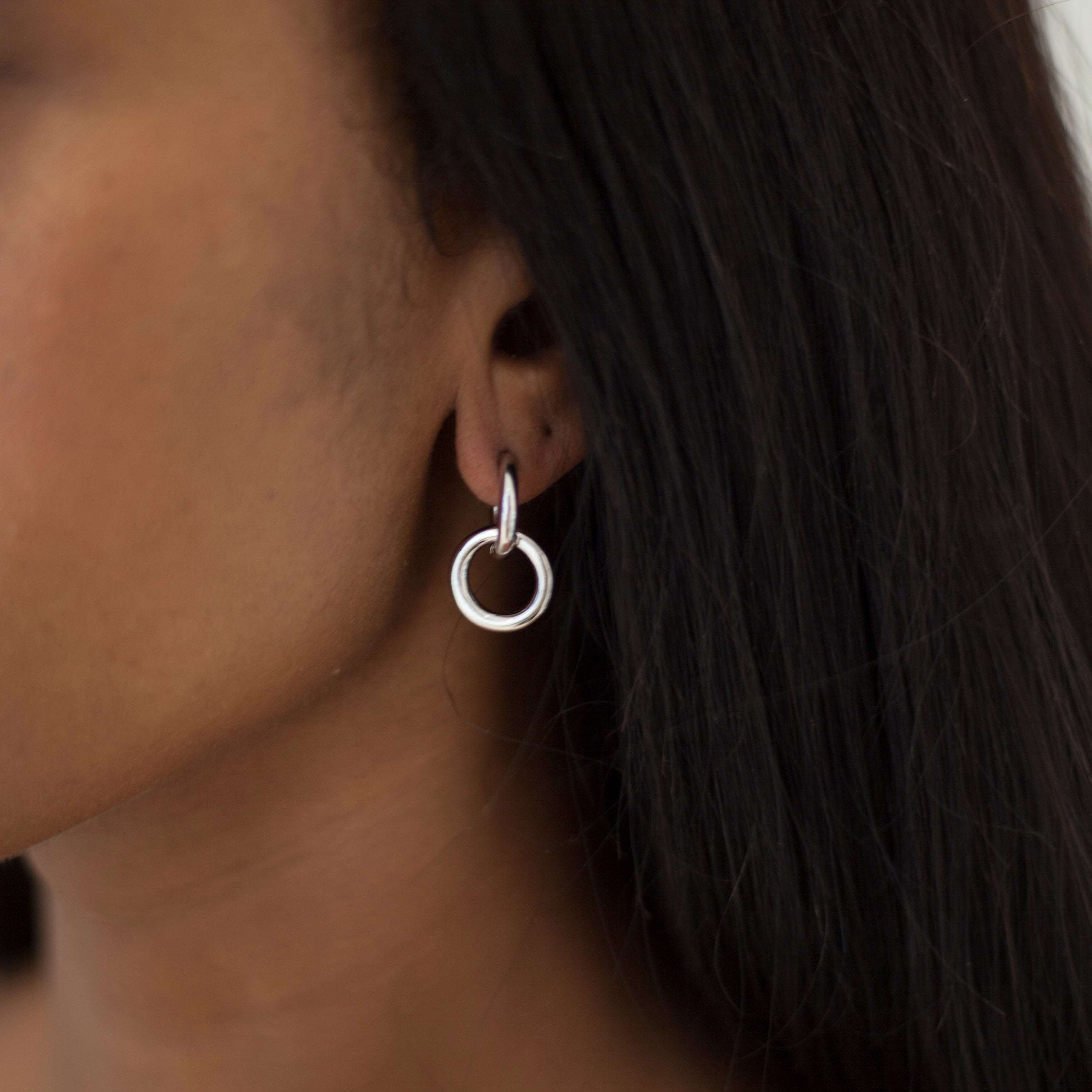 Silver huggie hoops with removable ring on model