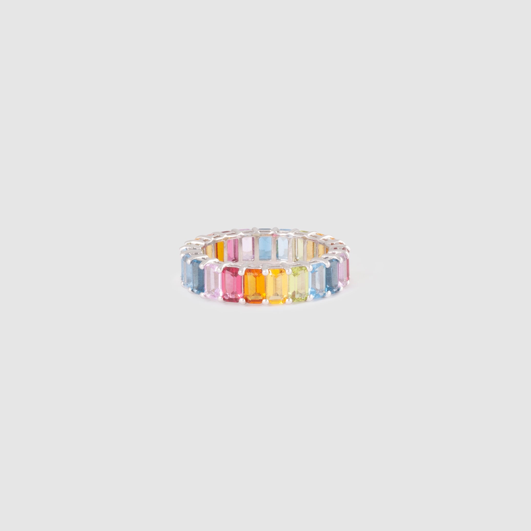 Ring featuring rainbow-coloured baguette stones set in a simple band