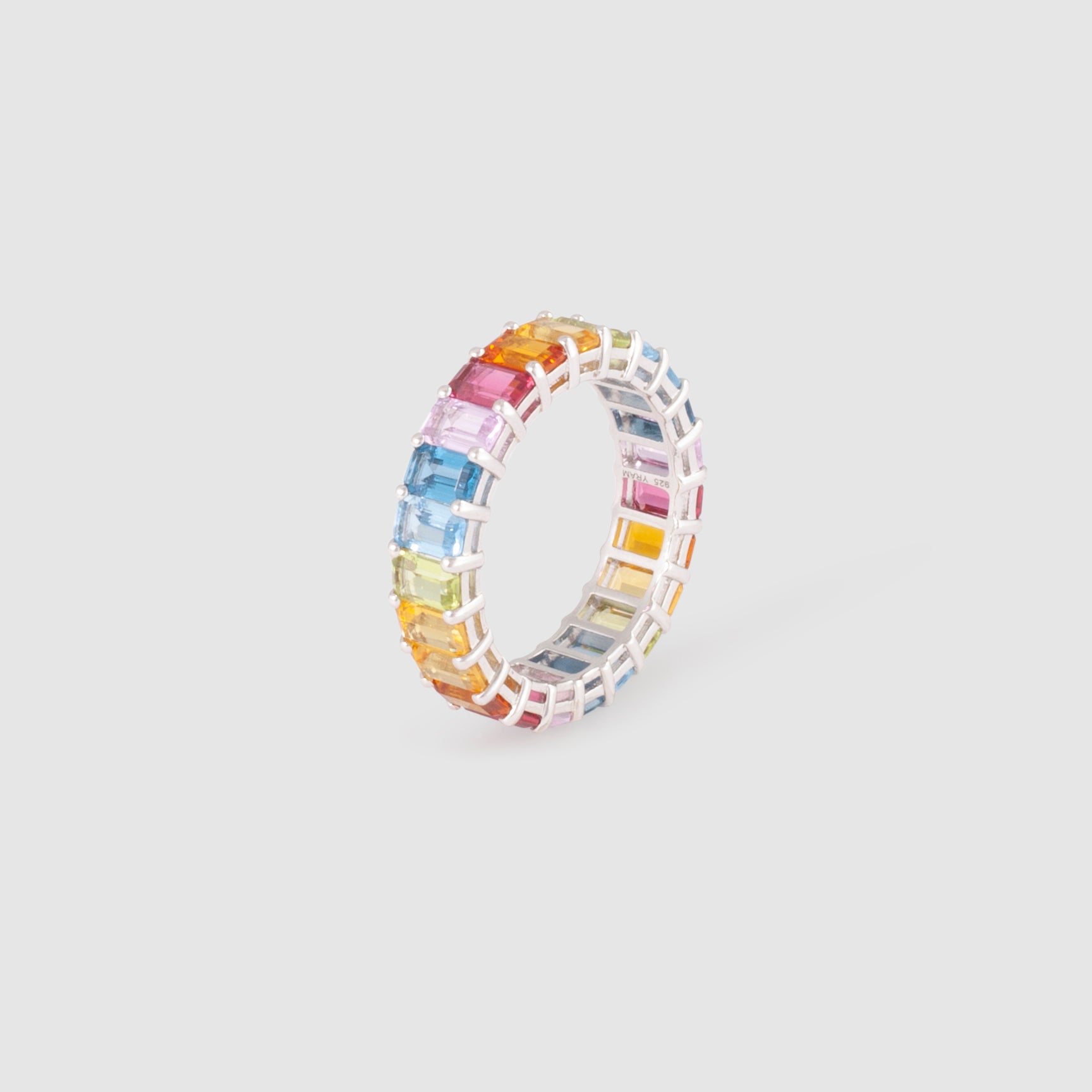 Ring featuring rainbow-coloured baguette stones set in a simple band