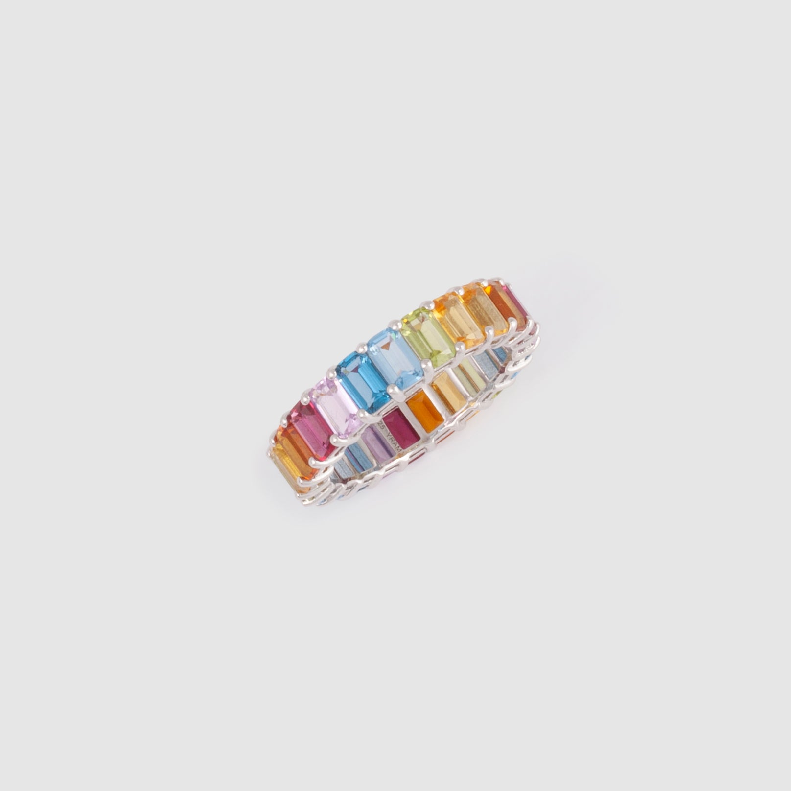 Ring featuring rainbow-coloured baguette stones set in a simple band