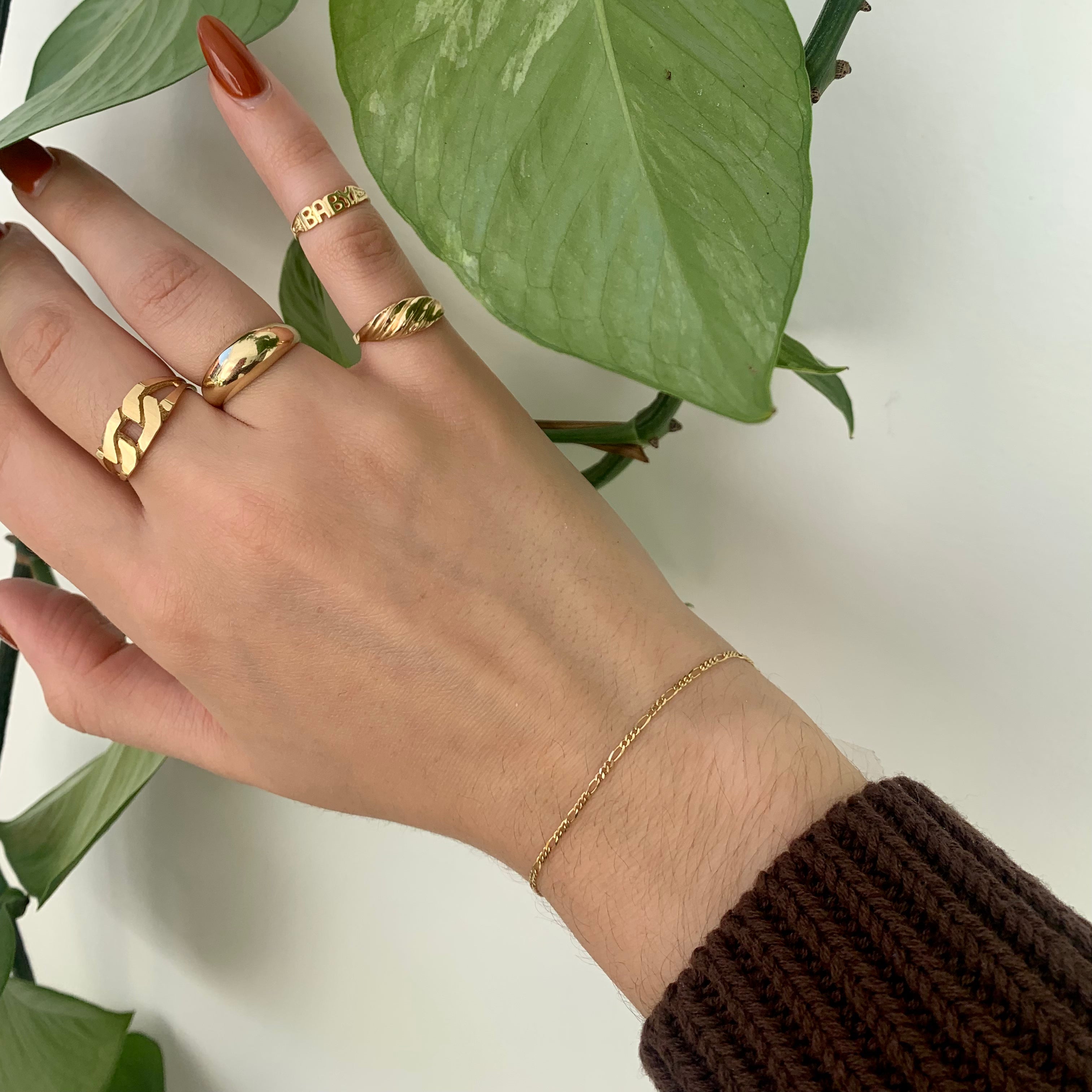 Ring stack featuring 10K Solid Yellow Gold ring with the detail of a Cuban link