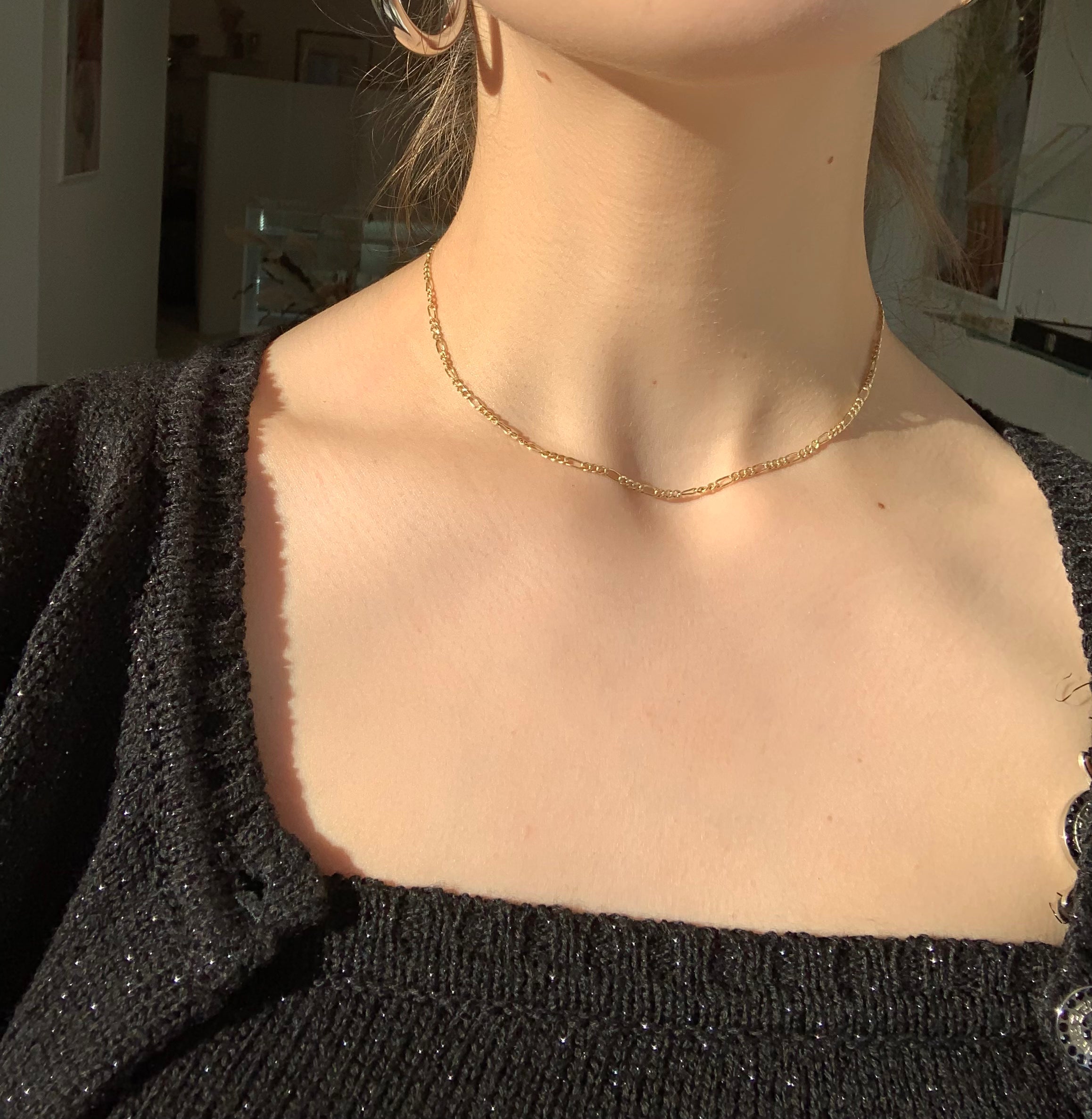 Thin figaro chain necklace on model