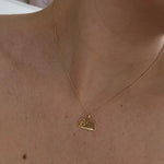10K gold "Bitch" pendant on a thin curb chain
